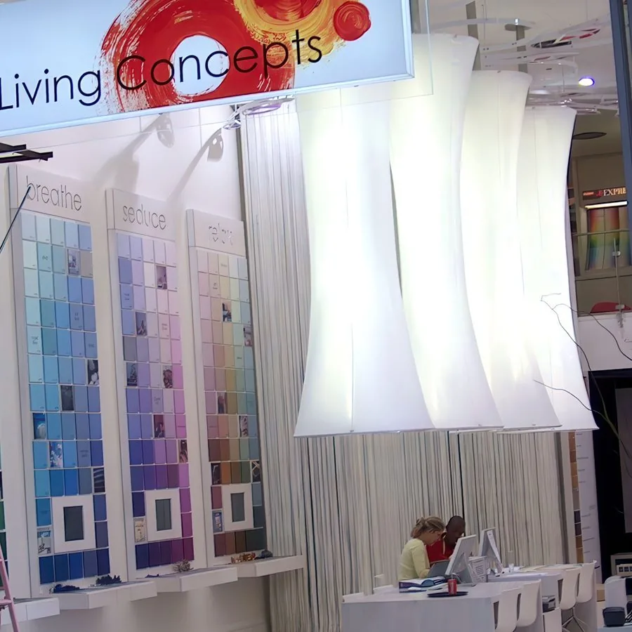 Sculptural white light fittings displayed in a paint showroom